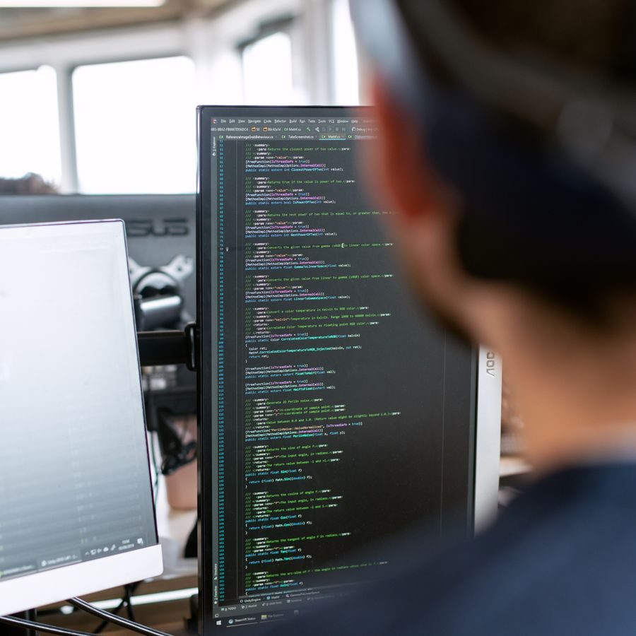 An engineer reviewing cloud configuration at his desk in a modern office