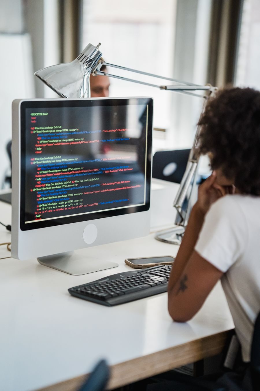 A developer reviewing pipeline configuration on her office desktop