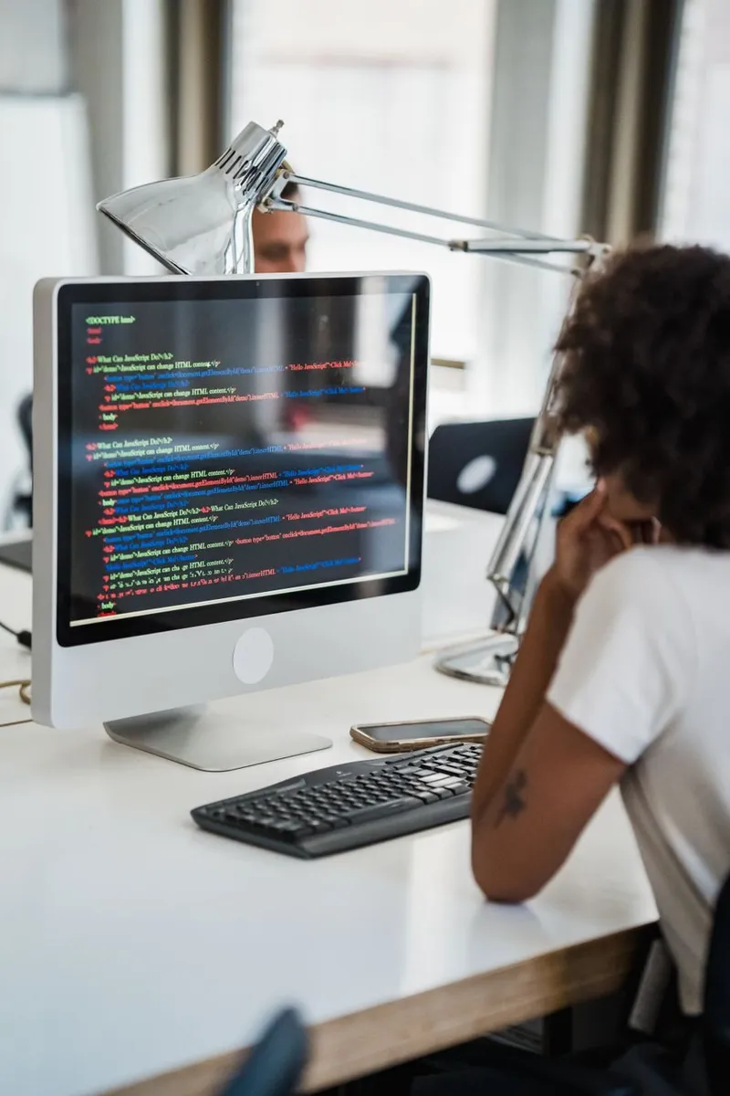 A developer reviewing pipeline configuration on her office desktop