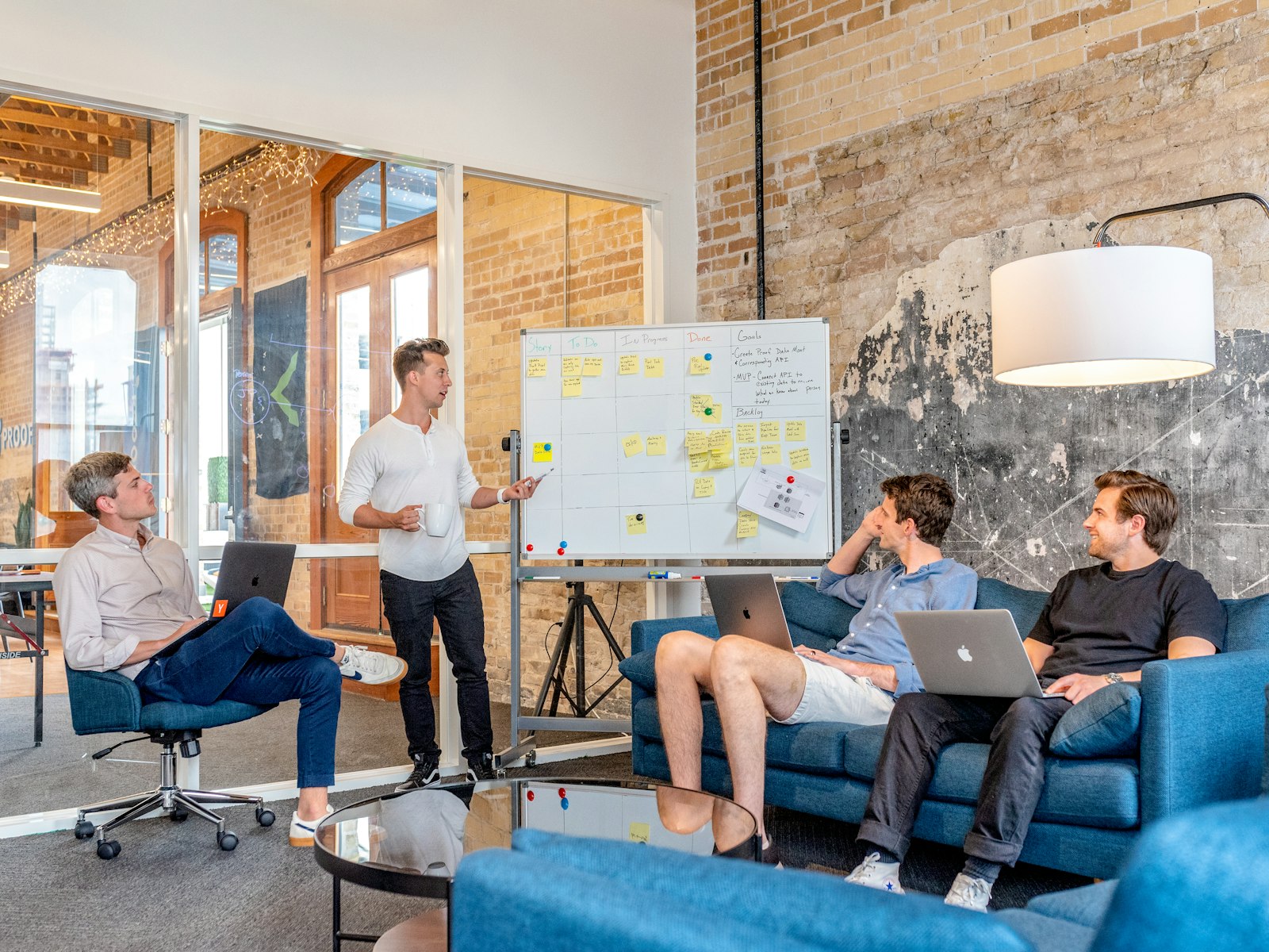 Colleagues planning around a whiteboard in a bright office