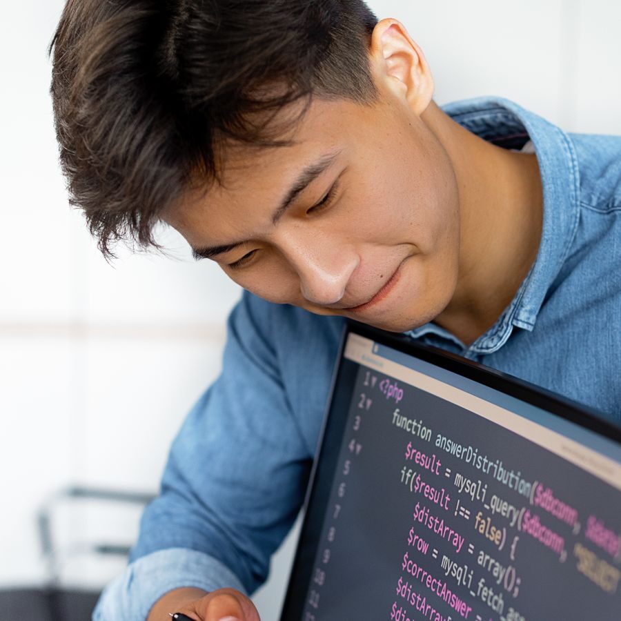 A colleague working at his laptop in a bright modern office